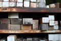 Stacks of ceramic kiln bricks on rusted metal shelves Royalty Free Stock Photo