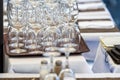 Stacks of clean empty glasses on trays in a street cafe, closeup Royalty Free Stock Photo