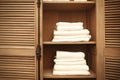 Stacks of clean white soft towels in cupboard in room Royalty Free Stock Photo