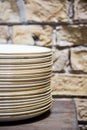 Stacks of cleaned white plates for catering buffet in restaurant room. Group plates stacked together