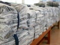 Stacks of clothes packed in plastic bags ready to be shipped / distributed Royalty Free Stock Photo