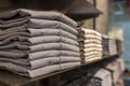 Stacks of clothing close-up, mens trousers in calm colors, blurr soft focus