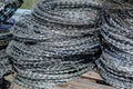 Stacks of coiled barbed wire for fencing and security applications Royalty Free Stock Photo