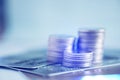 Stacks of coins and account book or credit card on working table Royalty Free Stock Photo