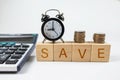 Stacks of coins, alarm clock and calculator. Savings concept Royalty Free Stock Photo