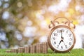 Stacks of coins and alarm clock on grass a background Royalty Free Stock Photo