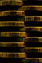 Stacks of coins closeup. Vertical money textured background. Dark brown business wallpaper made of many coin edges. Image with Royalty Free Stock Photo