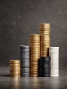 Stacks of Coins in Gold, Silver, and Black Arranged in a Pyramid Formation on a Textured Surface in a Well-Lit Setting Royalty Free Stock Photo