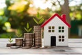 Stacks of coins with house model, symbolize rising interest rates Royalty Free Stock Photo