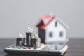 Stacks of coins and model house with percentage symbol for increasing interest rates. Interest rate financial and mortgage rates. Royalty Free Stock Photo