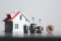 Stacks of coins and model house with percentage symbol for increasing interest rates. Interest rate financial and mortgage rates. Royalty Free Stock Photo