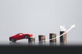 Stacks of coins and red car with percentage symbol for increasing interest rates. Interest rate financial and mortgage rates. Icon Royalty Free Stock Photo