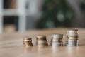 Stacks of coins on wooden tabletop