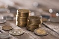 Stacks of coins on wooden tabletop