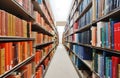 Stacks of colorful bound books on a library