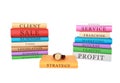 Stacks of colorful business books and a watch isolated on a white background