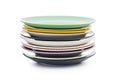 Stacks of colorful porcelain plates isolated on white background