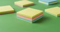 Stacks of colorful sticky notes are arranged on a green surface. Each stack includes Royalty Free Stock Photo