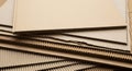 Stacks of corrugated cardboard sheets. Each sheet is composed of a flat linerboard and a fluted Royalty Free Stock Photo