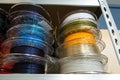 Stacks of 3d printing filament in different colors lying on shelf