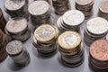 Stacks of different British coins on a white background.