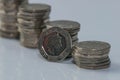 Stacks of different British coins on a white background.