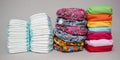 Stacks of disposable diapers and modern cloth diapers