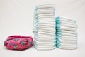 Stacks of disposable diapers and modern cloth diapers