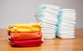 Stacks of disposable diapers and modern cloth diapers