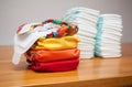 Stacks of disposable diapers and modern cloth diapers