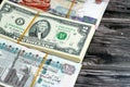 Stacks of Egyptian and American currency cash money banknotes with rubber bands of 2 two American dollars and 100 EGP , 200 LE one Royalty Free Stock Photo