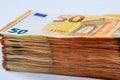 Stacks of euro banknotes on a white background in fifty euro.