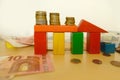 stacks of euro currency coins on colored wooden blocks design, concept monetary recession, inflation, drop in sales, production,