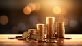 Stacks of Glimmering Gold Coins on a Table with a Radiant Glowing Background Royalty Free Stock Photo