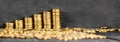 Stacks of gold coins banner.Gold coins on a wooden table. Money on a black background.Copy space. Treasure Hunt.Chalk Royalty Free Stock Photo