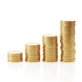 Stacks of gold coins, increasing in size, isolated on white background Royalty Free Stock Photo