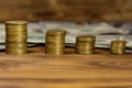 Stacks of golden coins and dollar bills on wooden background Royalty Free Stock Photo