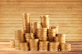 Stacks of golden coins on wooden table background Royalty Free Stock Photo