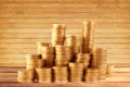 Stacks of golden coins on wooden table background Royalty Free Stock Photo