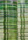 Data storage image with layered stacks of translucent green gold DVD and CD computer storage disks Royalty Free Stock Photo