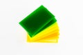 Stacks of green yellow pieces of Plexiglas