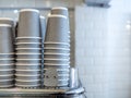 Stacks of grey paper cups and coffee cups Royalty Free Stock Photo