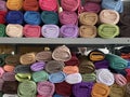 Stacks of hijabs, headscarves of various colors in rolls