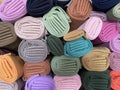 Stacks of hijabs, headscarves of various colors in rolls