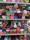 Stacks of hijabs, headscarves of various colors in rolls