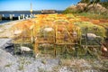 Stacks of lobster traps at the pier on the shore of a fishing harbor Royalty Free Stock Photo