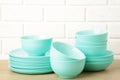 Stacks of mint ceramic dishware on light background Royalty Free Stock Photo