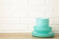 Stacks of mint ceramic dishware on light background Royalty Free Stock Photo