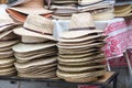 Stacks of natural color beautiful straw hats