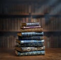 Stacks of old books on wooden desk in old library. Ancient books historical background. Retro style. Conceptual background on Royalty Free Stock Photo